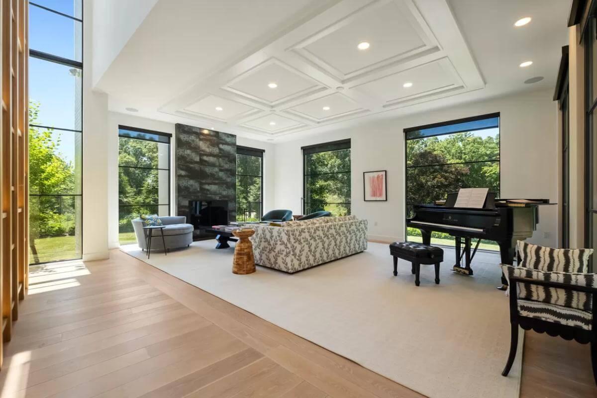 Spacious Living Room with Grand Piano and Striking Fireplace