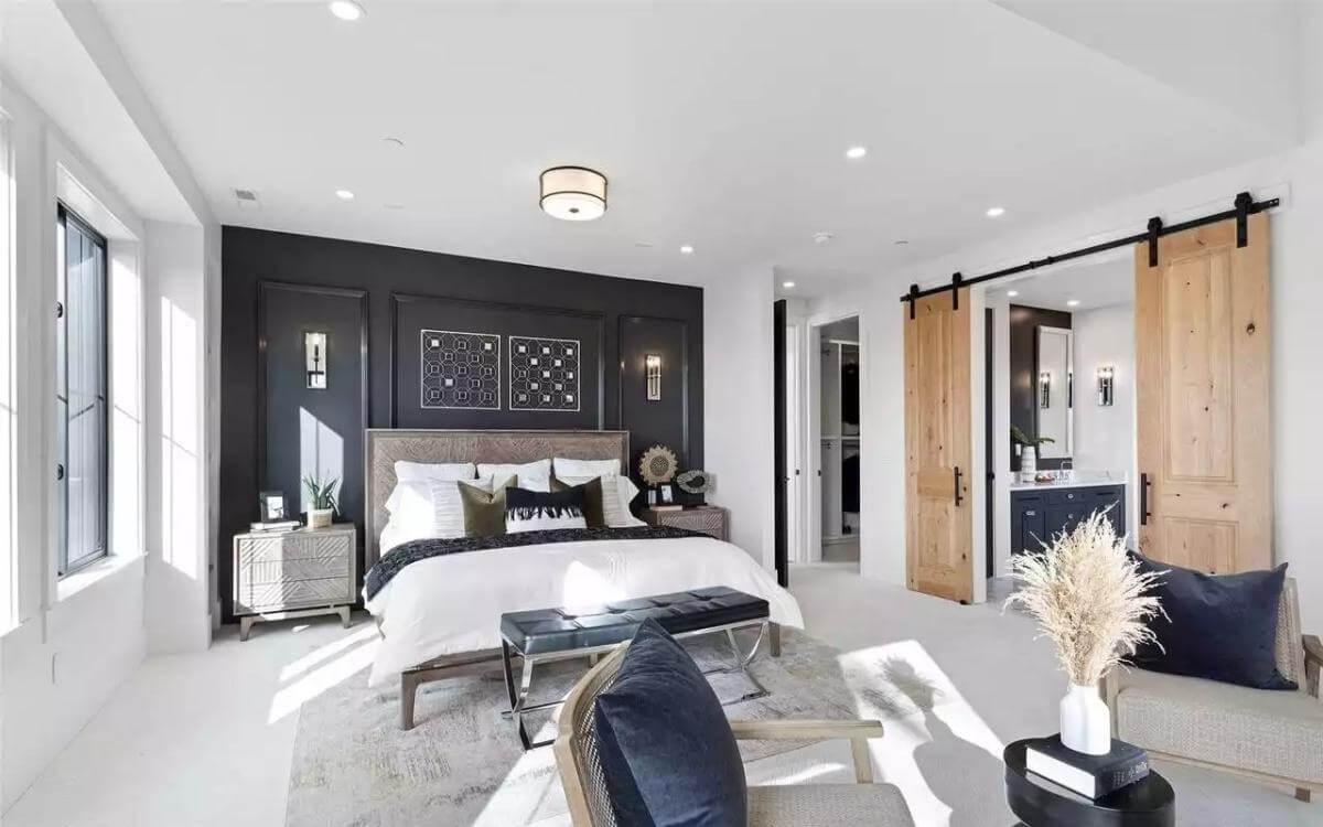 Master Bedroom Elegance with Bold Black Accent Wall and Sliding Barn Doors