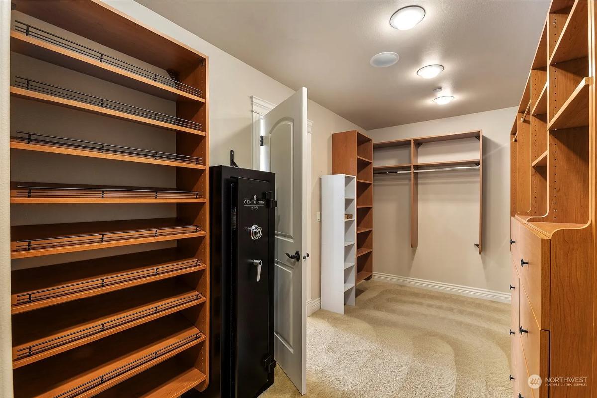 Explore This Well-Organized Closet with Built-In Shelving and Security Safe