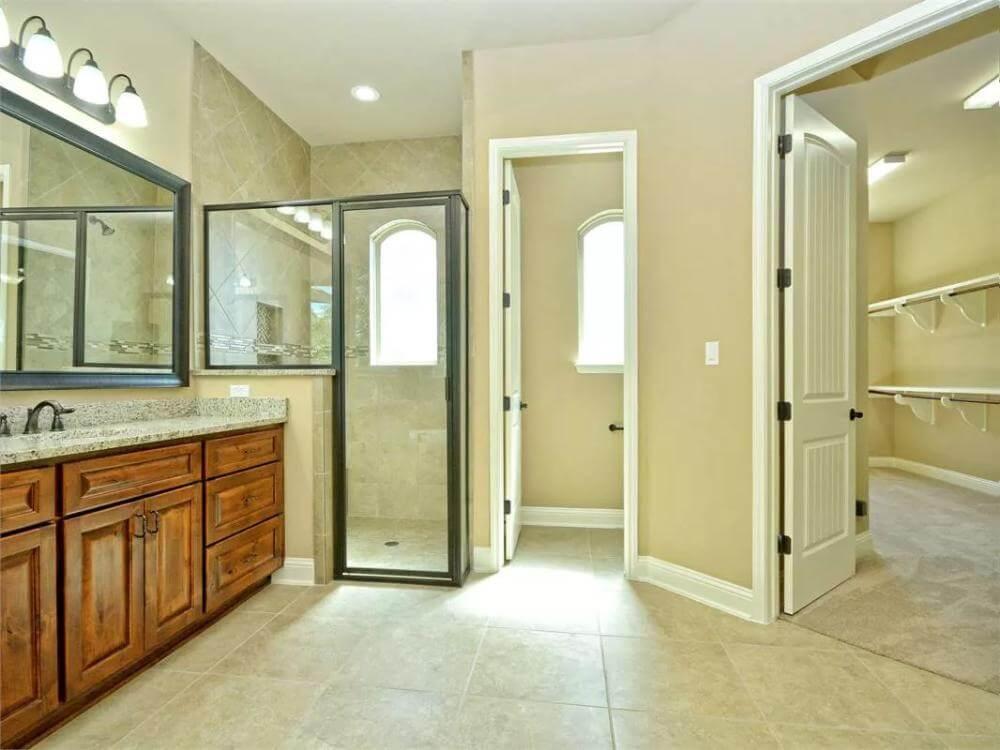 Inviting Bathroom Layout with a Walk-In Closet Connection