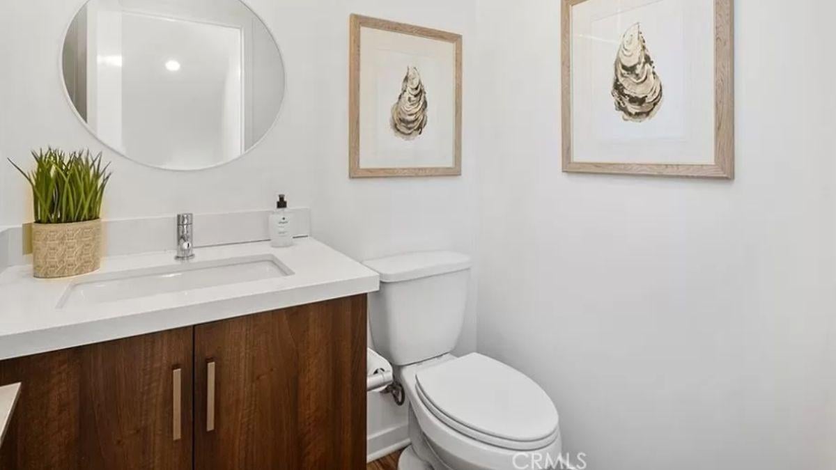 Notice the Verdant Touch Paired with Natural Art in This Compact Powder Room