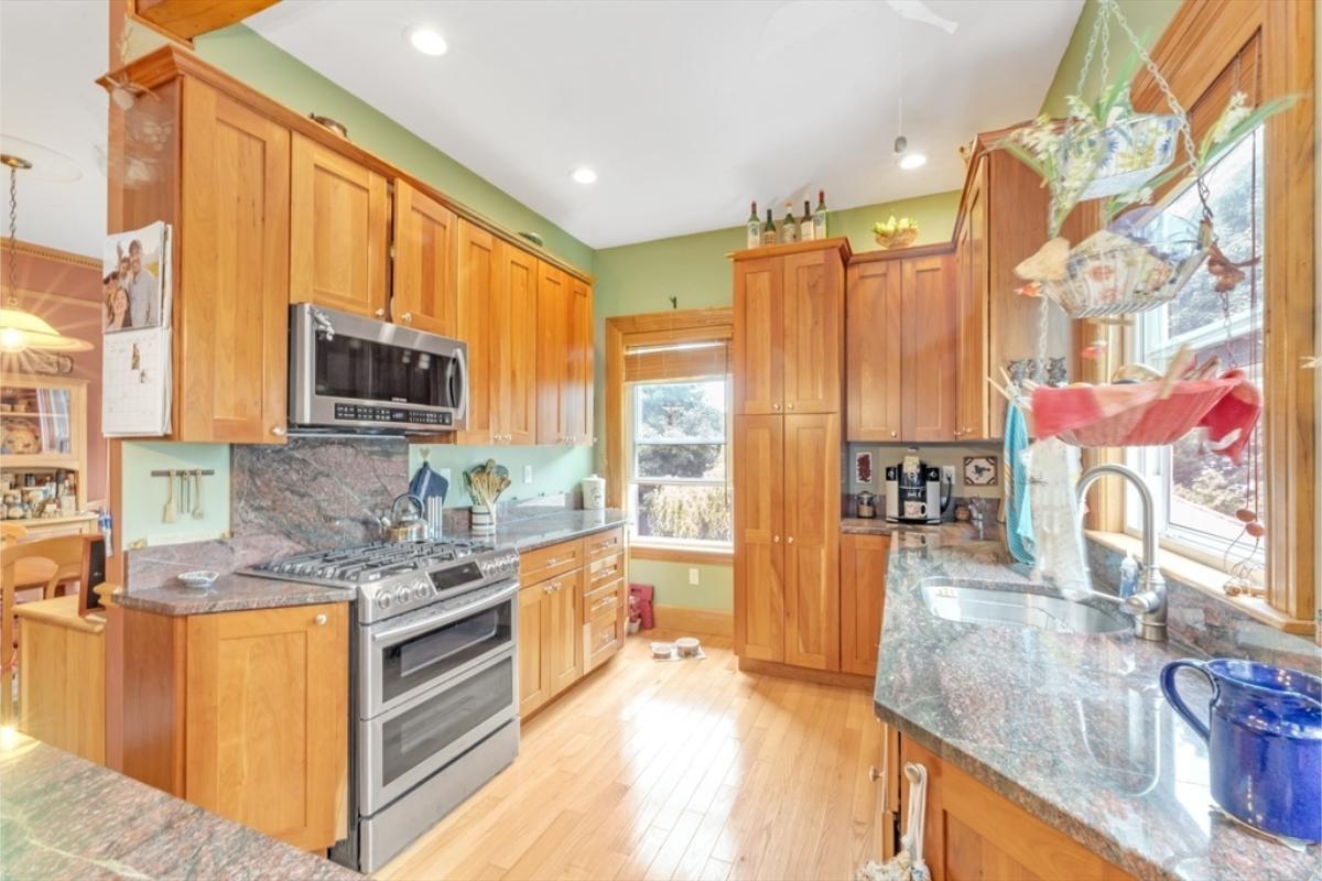 Warm Kitchen with Rich Wooden Cabinets and Granite Counters
