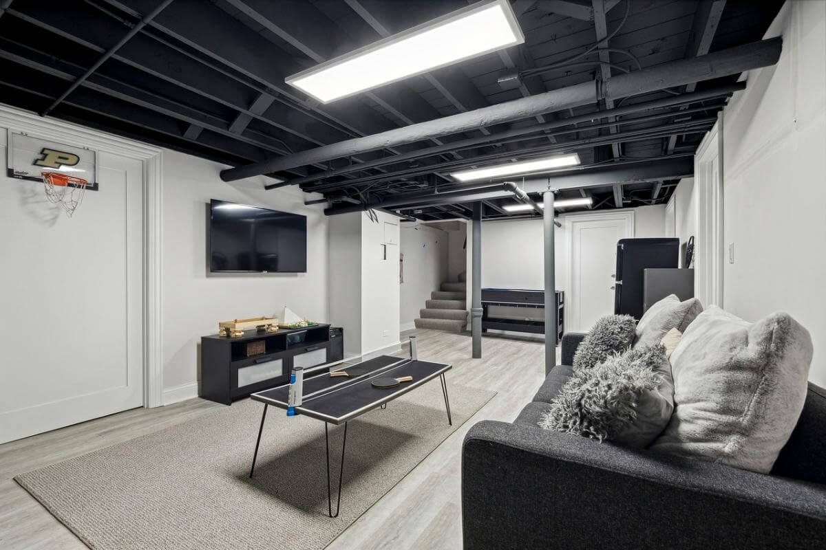 Basement Retreat with a Ping Pong Table and Cozy Seating Area