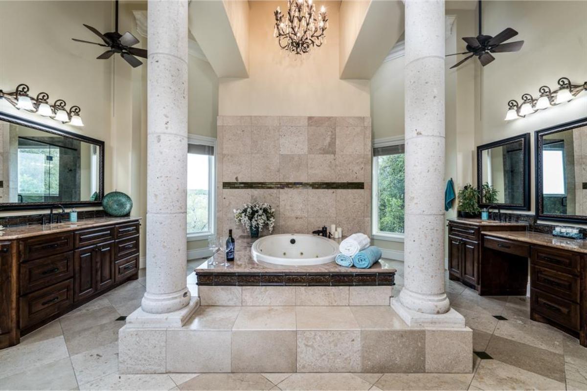 Luxury Bathroom with Roman Columns and a Soaking Tub as the Focal Point