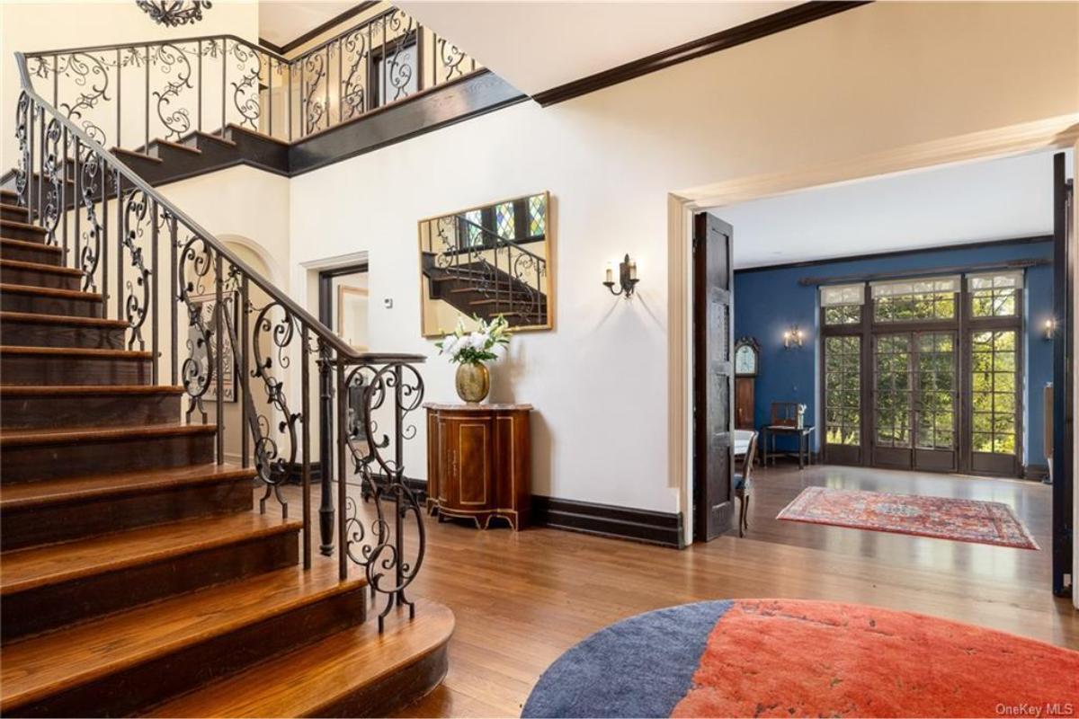 Experience Elegance: Curved Staircase with Ornate Ironwork
