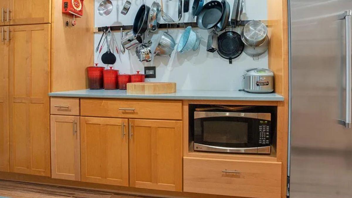 Spot the Efficient Pot Rack in This Warm Kitchen Space