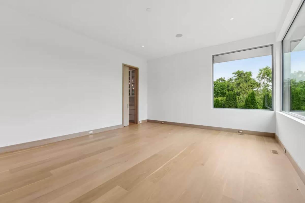 Spacious Bedroom with Serene Views Through Expansive Windows