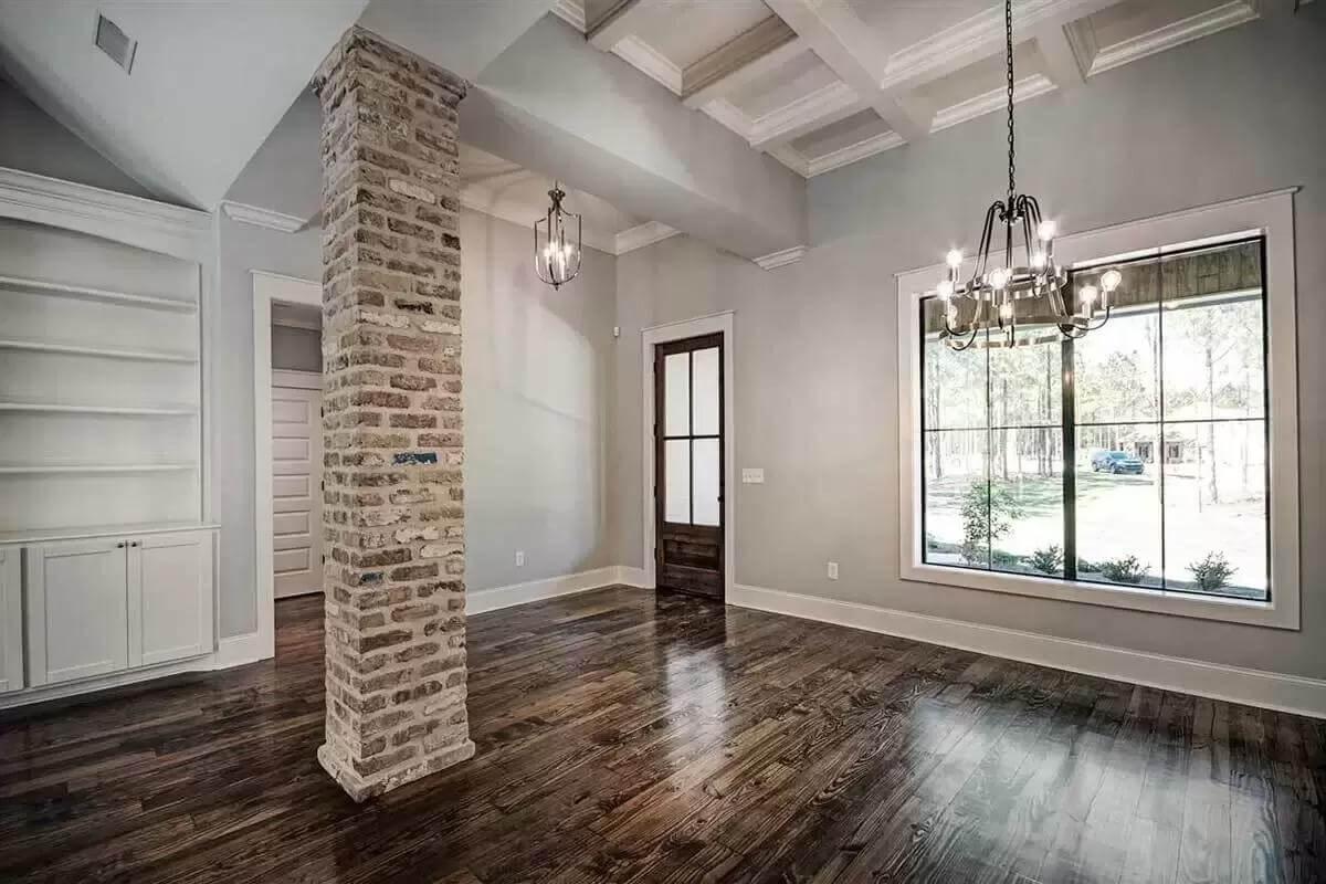 Admire the Brick Column and Gleaming Wooden Floors in the Dining Area