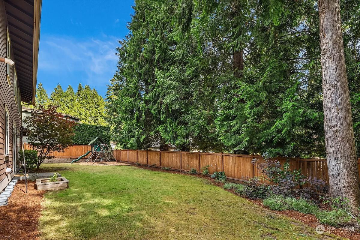 Family-Friendly Craftsman Backyard with Playset and Towering Trees