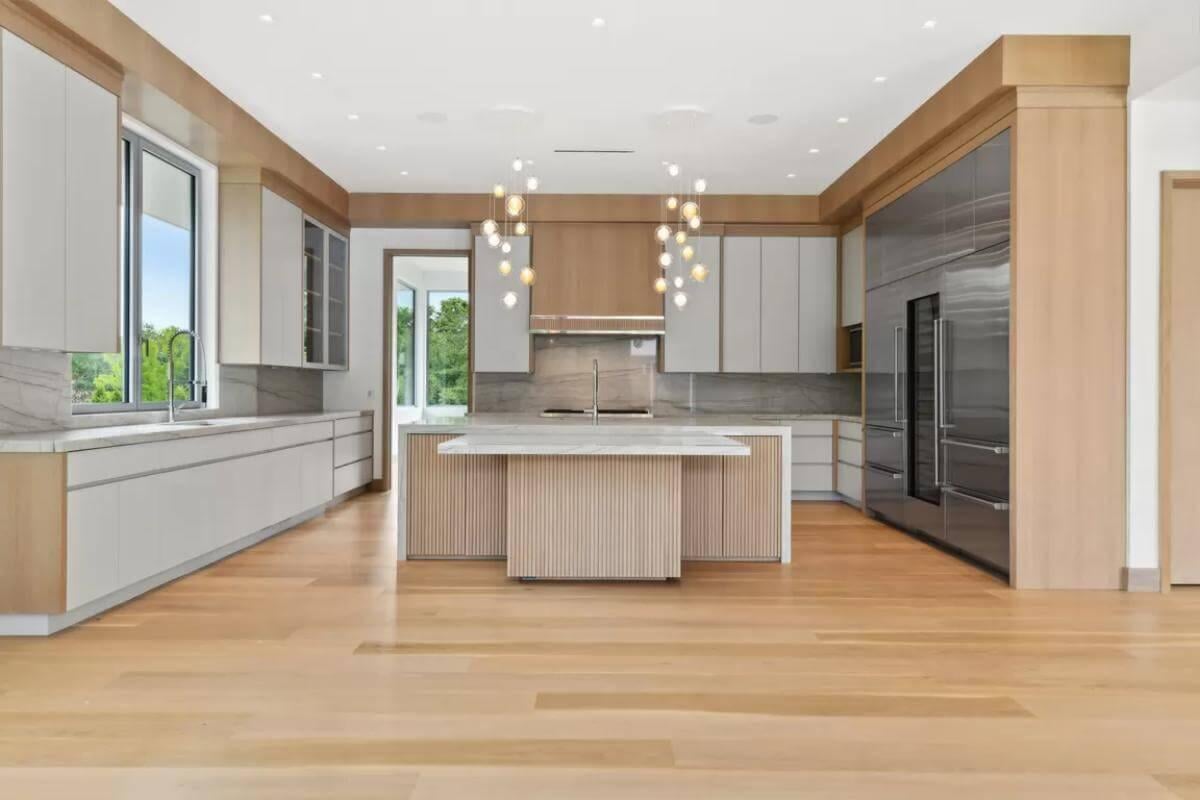 Sleek Kitchen with Luminous Pendant Lighting and Integrated Cabinets