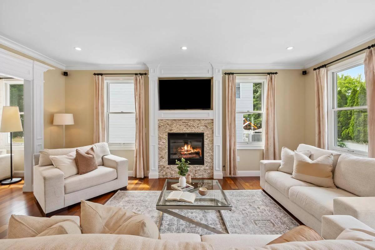Warm Living Room with a Cozy Fireplace and Elegant Draperies