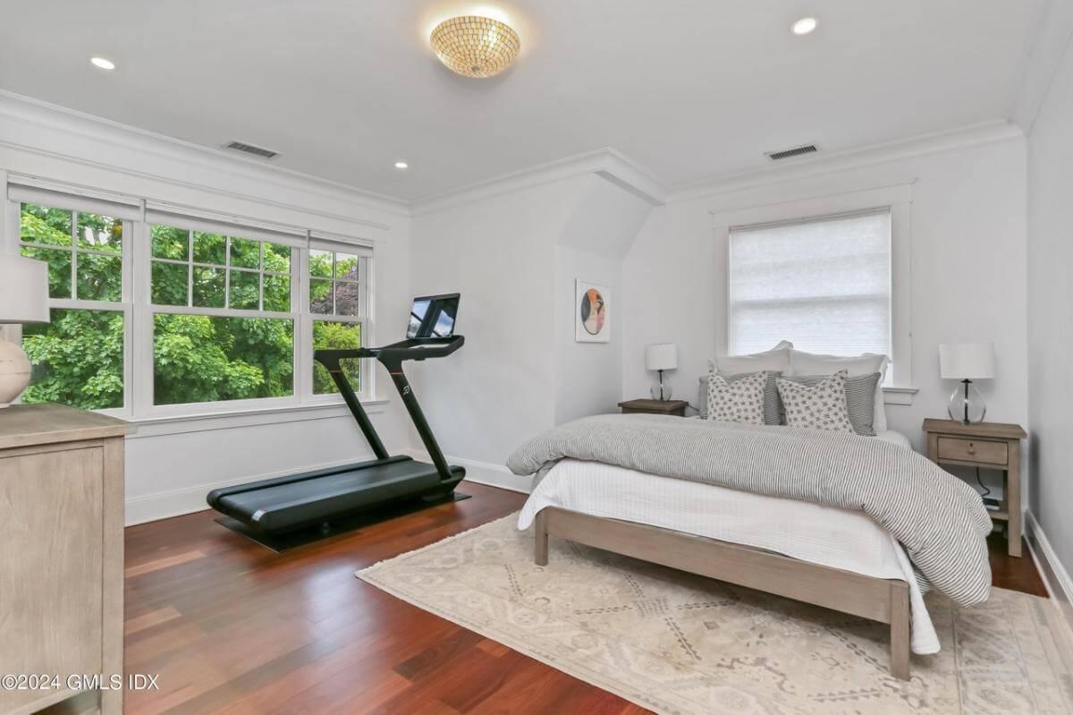 Check Out This Versatile Bedroom with a Treadmill and Large Windows