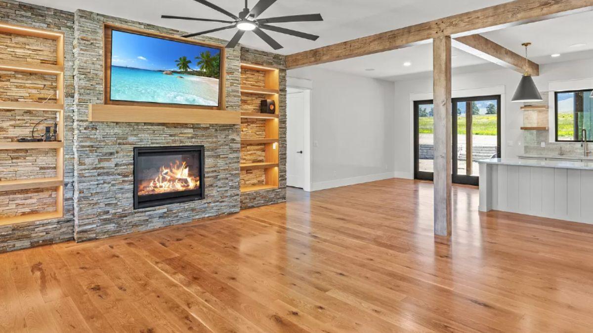Admire the Stone Fireplace and Open Beam Ceilings in This Inviting Space