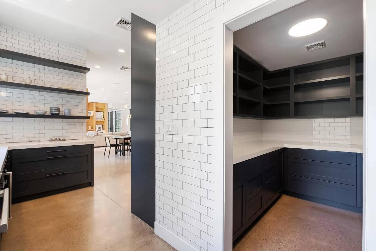 Sleek Modern Pantry Featuring Subway Tile and Open Shelving