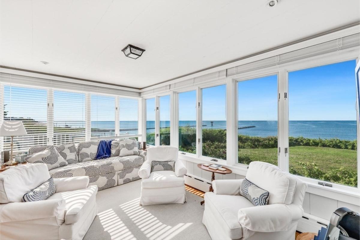 Sunroom Bliss with Expansive Ocean Views and Cushioned Comfort