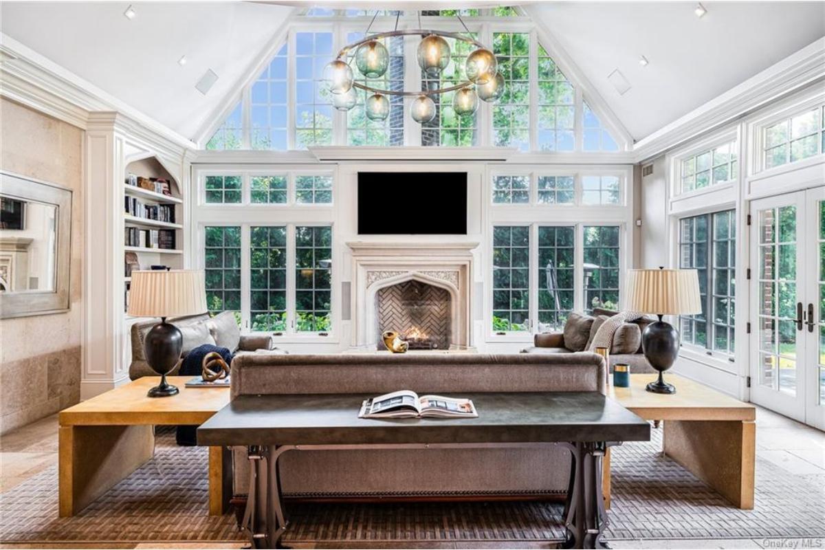 Marvel at the Vaulted Ceiling and Expansive Windows in This Living Room