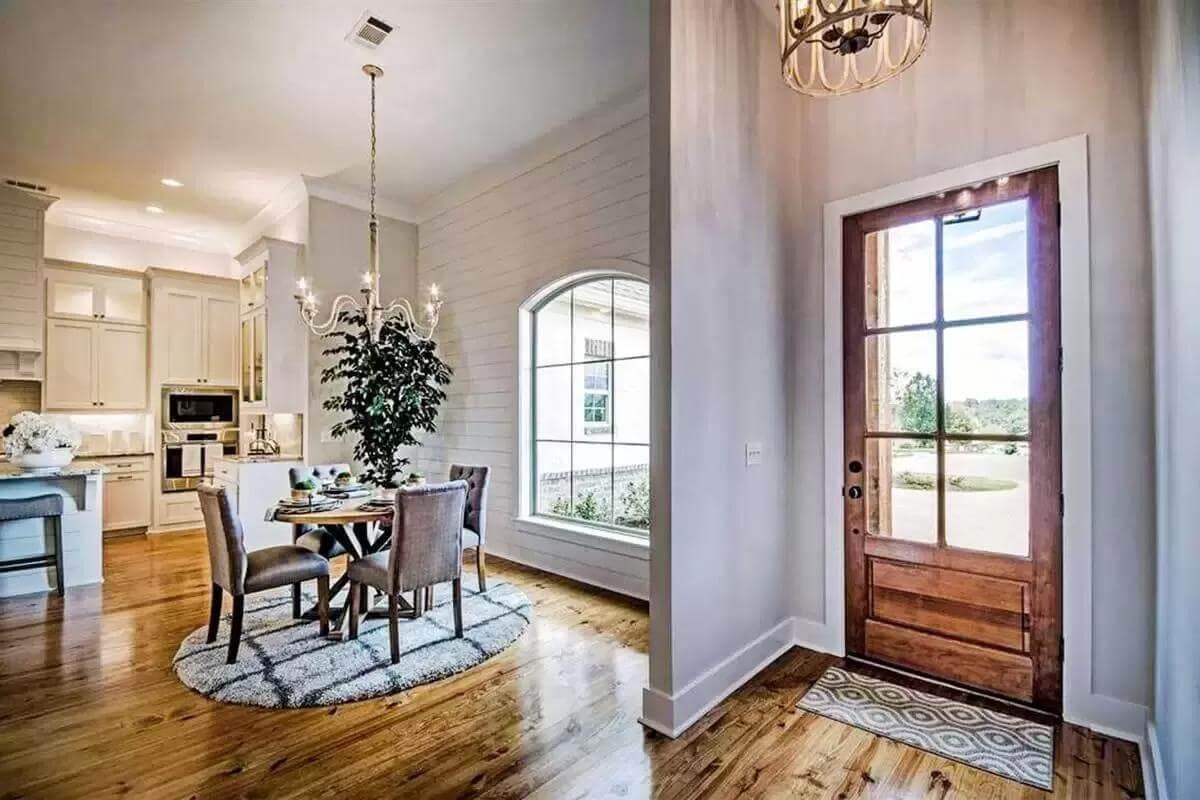 Welcoming Entry with Natural Light and Elegant Dining Space