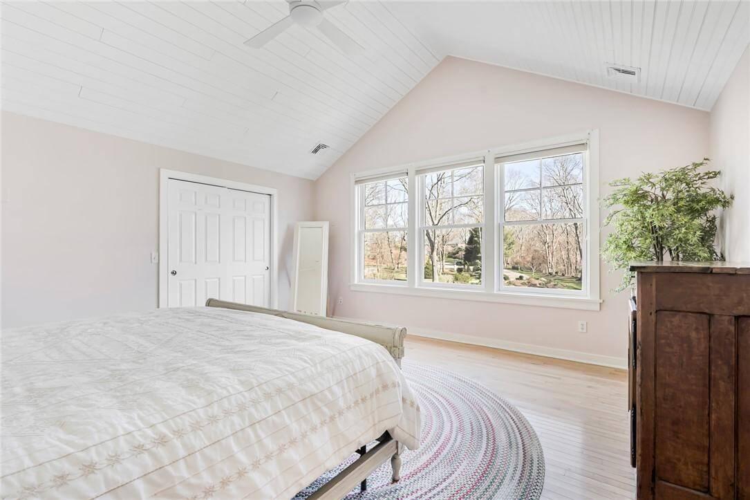 Natural Light Pours into This Peaceful Bedroom with Vaulted Ceilings