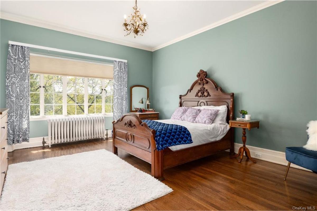 Notice the Antique Bedframe in This Tranquil Bedroom with Soft Hues