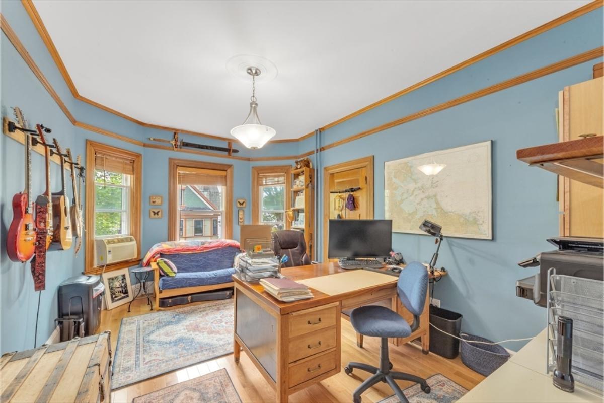 Notice the Guitars on Display in This Dynamic Home Office