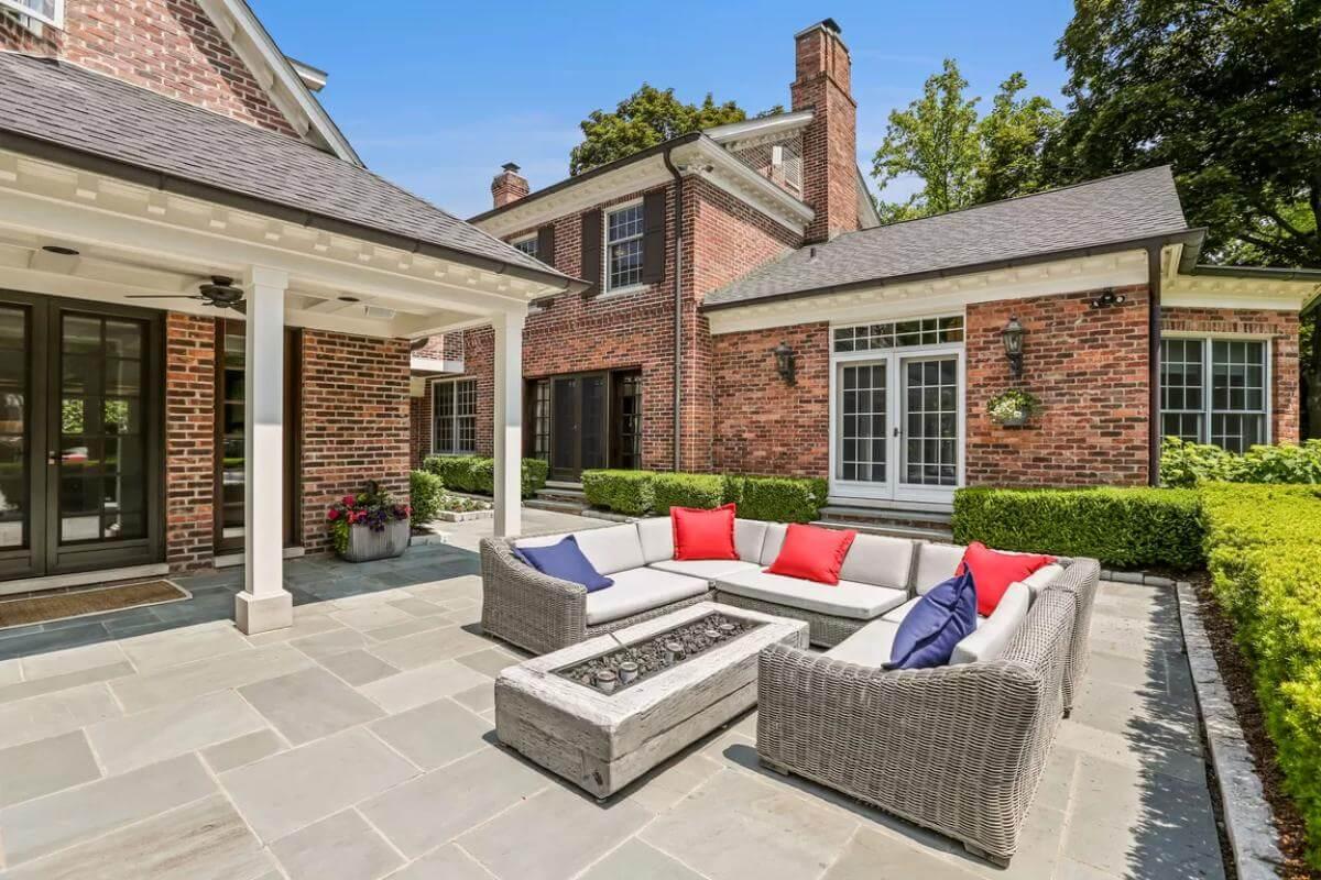 Outdoor Patio with Brick Walls, Comfortable Seating, and a Fire Table