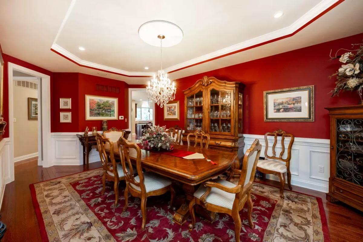 Formal Dining Room with Bold Red Walls and Classic Wood Elegance