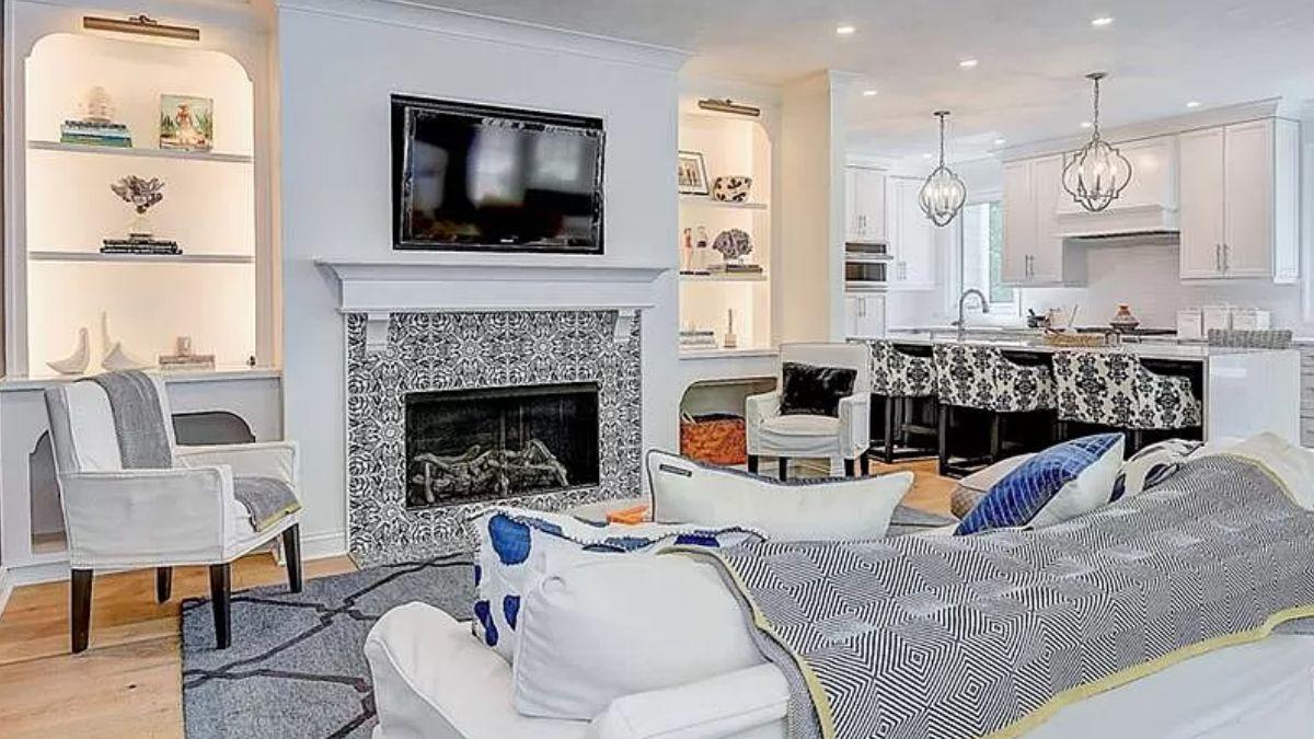 Cozy Up to the Ornate Fireplace in This Stylish Living Area
