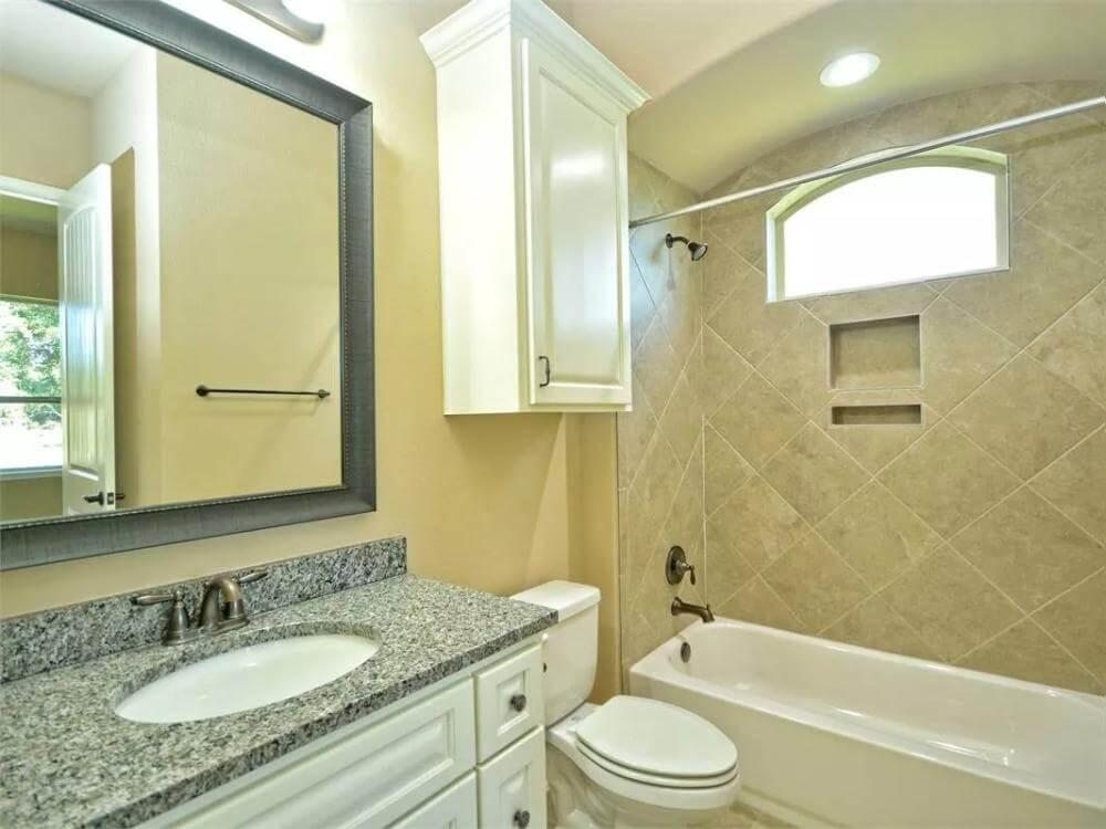 Notice the Luminous Bathroom with a Tiled Shower Niche