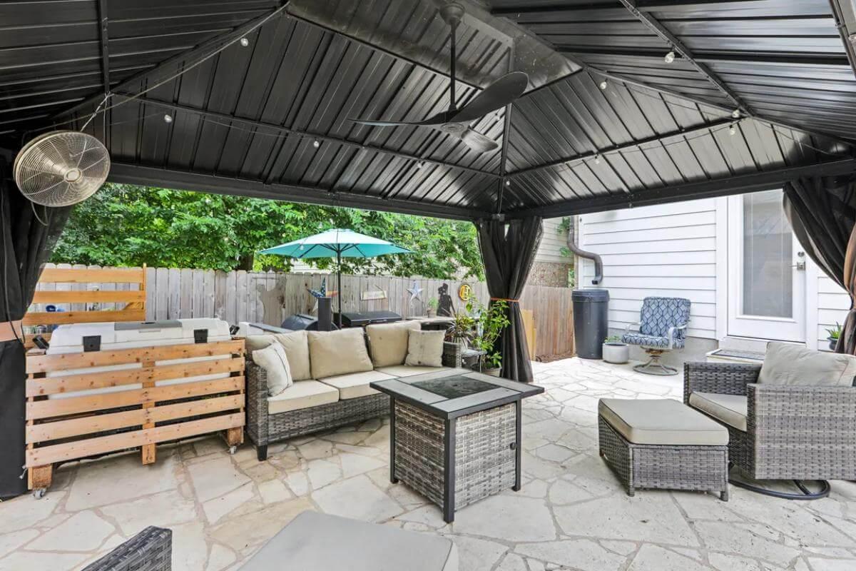 Step into the Relaxed Sophistication of This Covered Patio with Stone Flooring