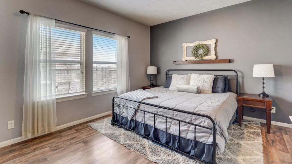 Serene Bedroom with Wrought Iron Bed and Rustic Decor
