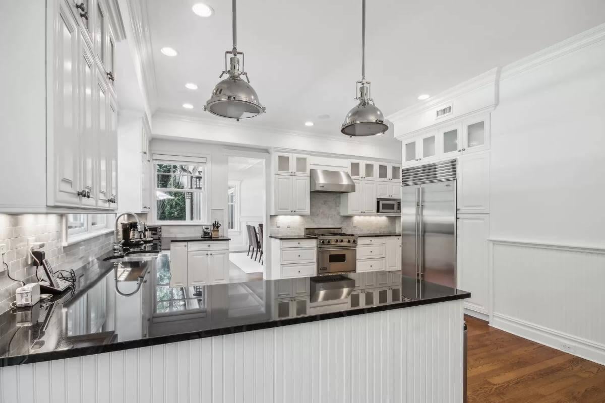 Gourmet Kitchen with Black Countertops and Industrial Pendant Lights