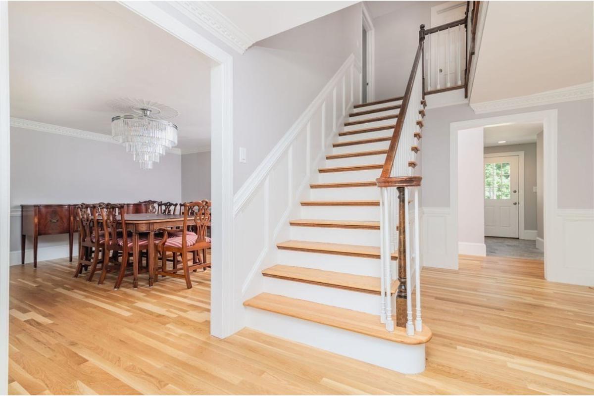Grand Entrance with Elegant Staircase and Dining Room in View