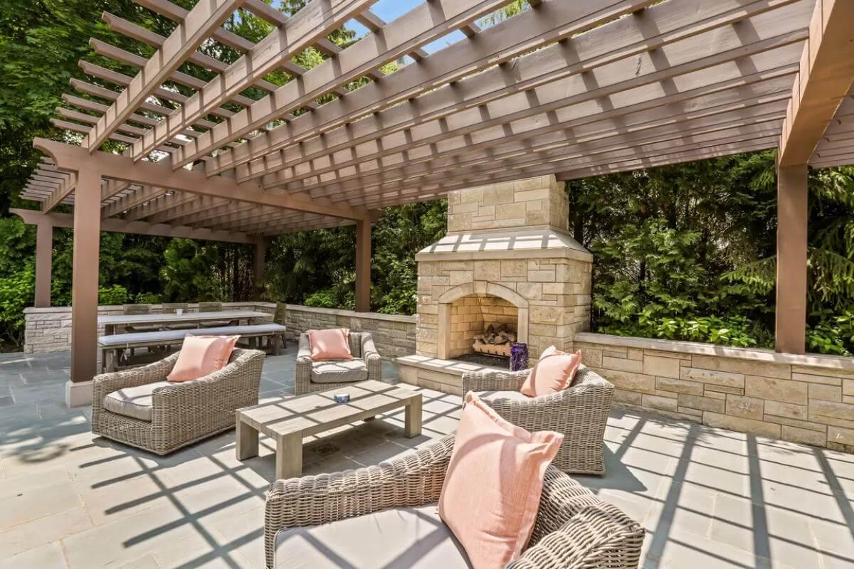 Outdoor Haven with Pergola and Cozy Stone Fireplace