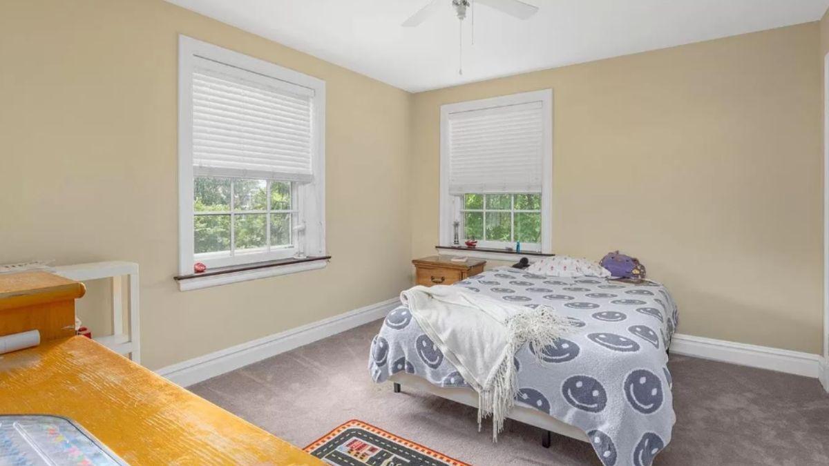 Unwind in This Simple Bedroom with Twin Windows and Wooden Touches