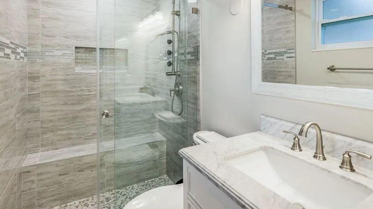 Notice the Elegant Walk-In Shower with Mosaic Accents