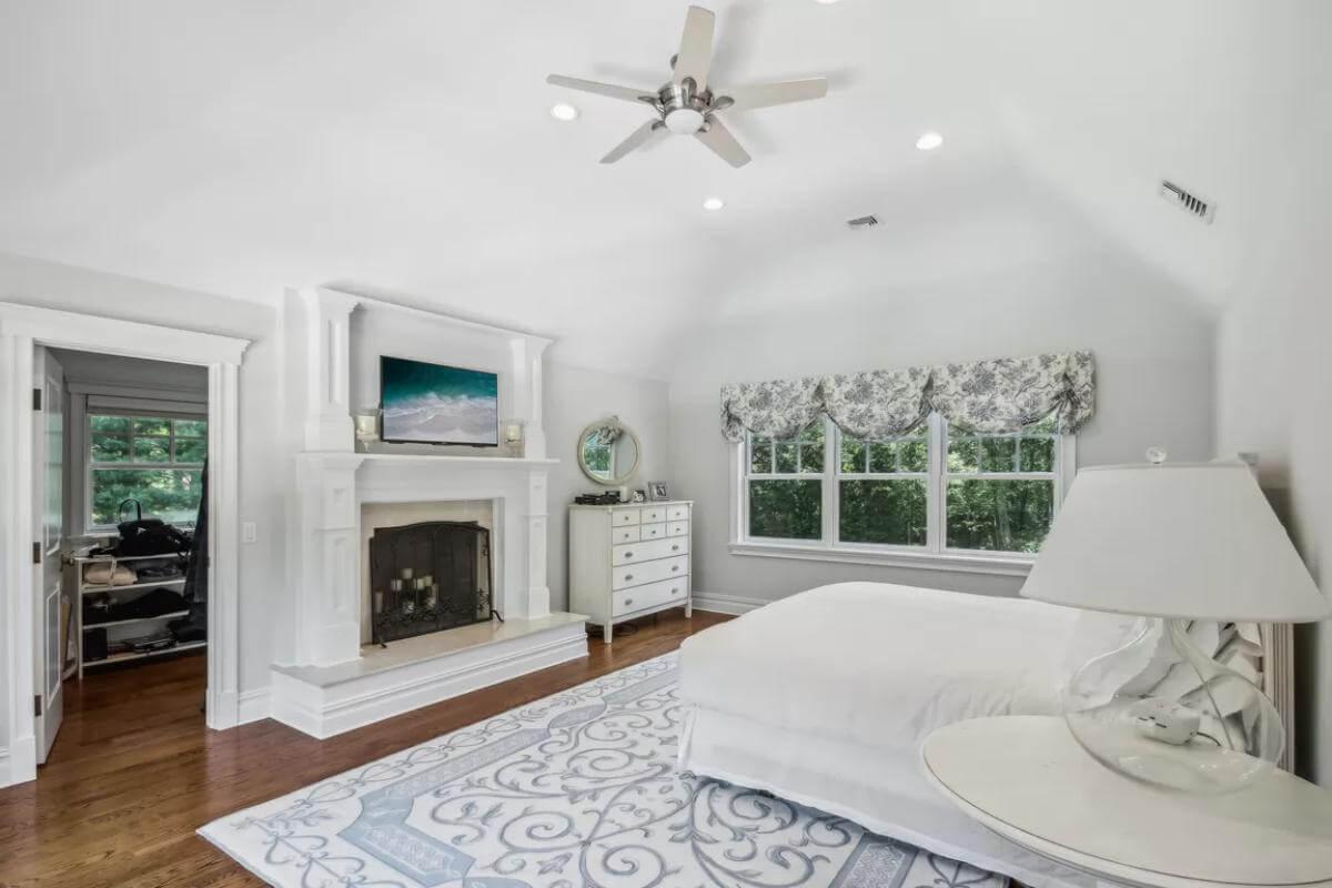 Experience Serenity in This Elegant Bedroom with a Fireplace Centerpiece
