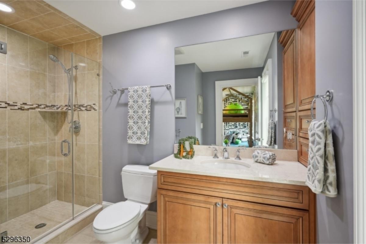 Contemporary Bathroom with Warm Wood Cabinets and Tiled Shower