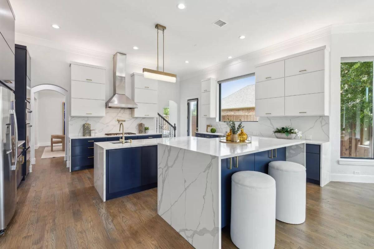 Striking Two-Tone Kitchen With Marble Island as a Centerpiece
