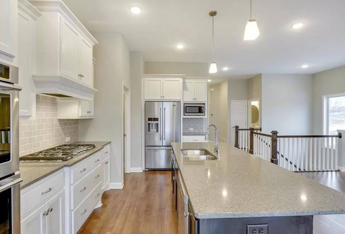Explore the Craftsman Kitchen Featuring a Sleek Island and Subway Tile Backsplash