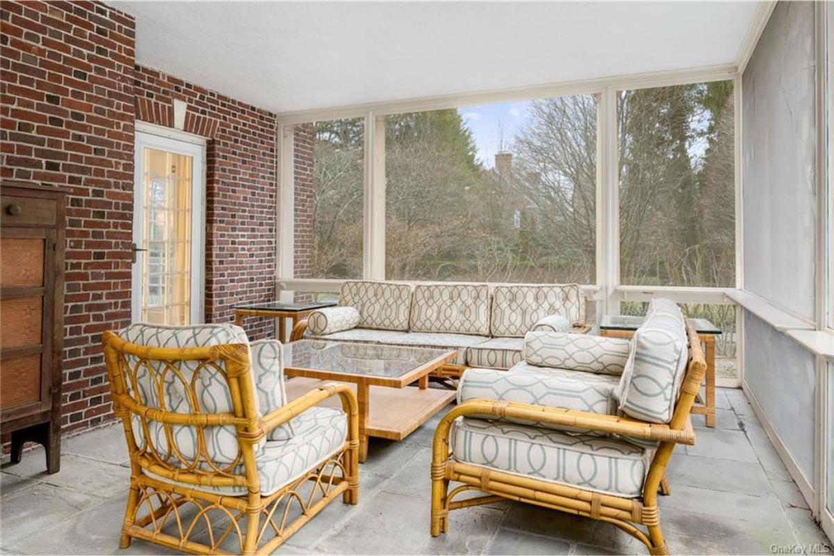 Charming Sunroom with Rattan Furniture and Brick Accents