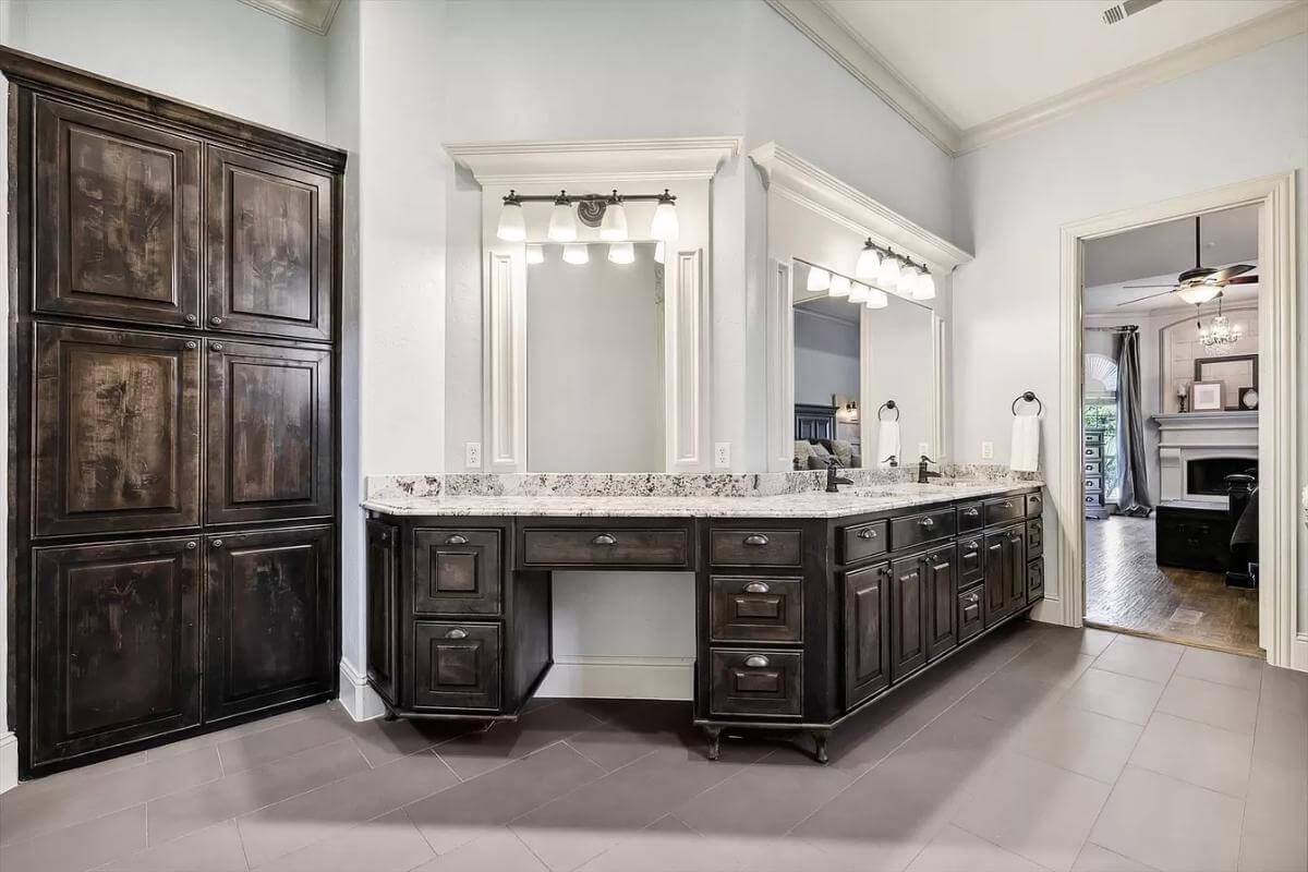 Elegant Bathroom with Dark Cabinetry and Classic Granite Vanity