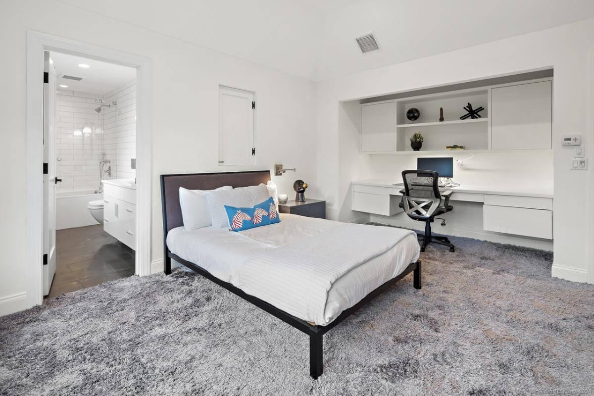 Modern Bedroom with Integrated Workspace and a Soft Rug