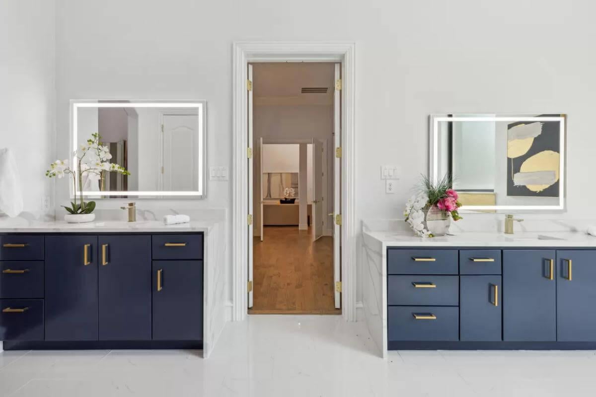 Dual Vanity Bathroom with Elegant Navy Cabinets and Subtle Gold Touches