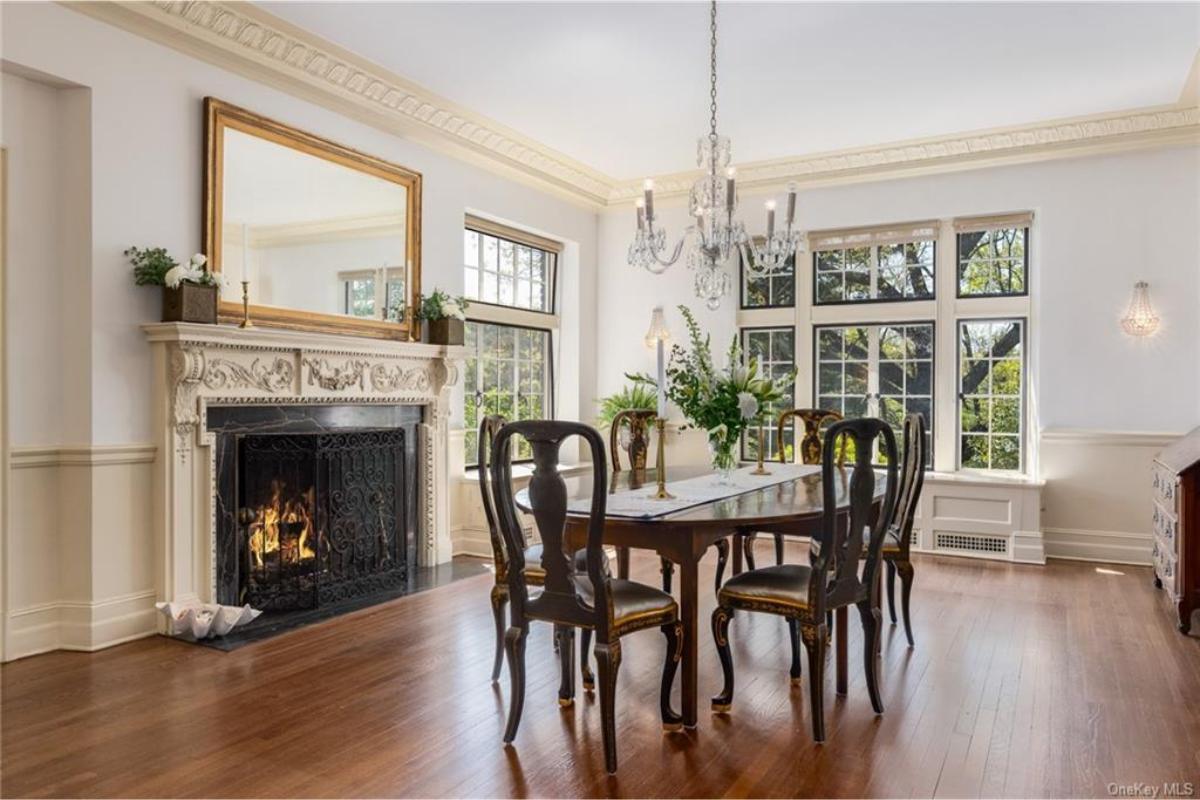 Elegant Dining Room with Ornate Fireplace and Crystal Chandelier
