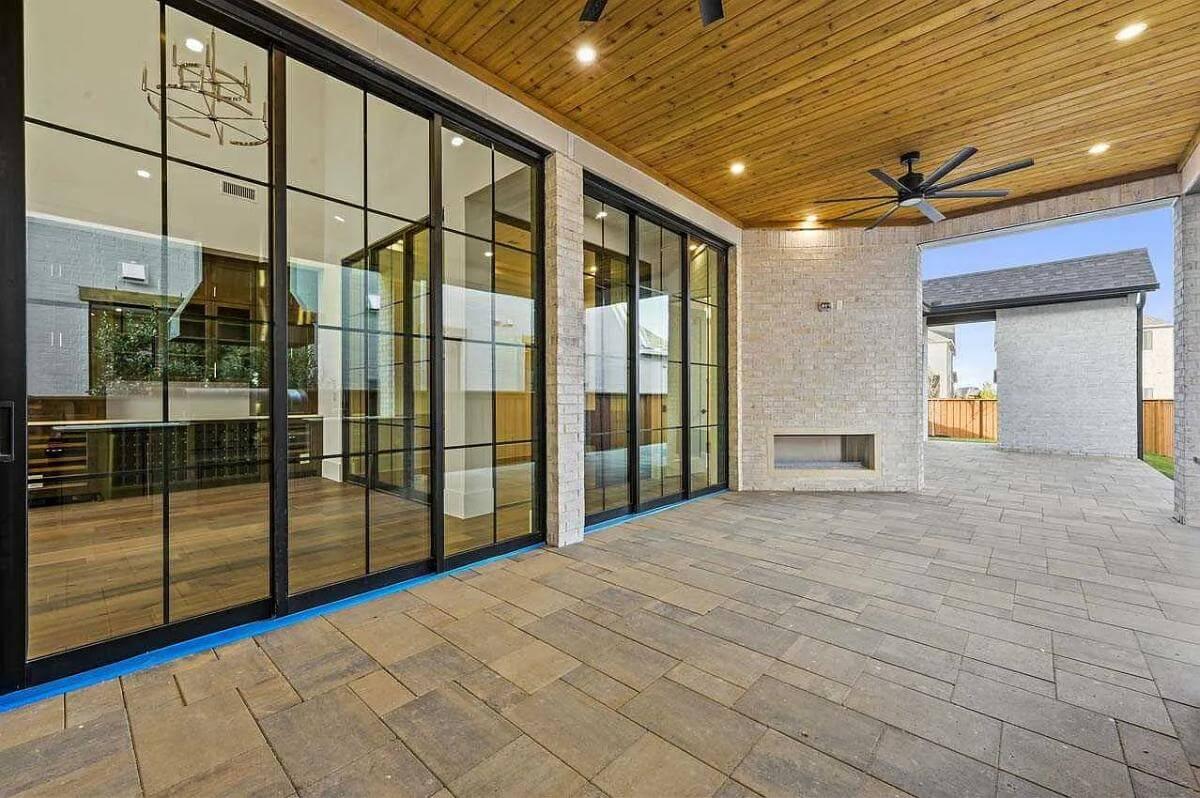 Take In the Expansive Glass Doors and Wood Ceiling on This Patio