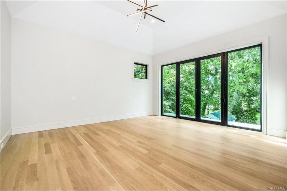 Look at Those Floor-To-Ceiling Windows in This Serene Bedroom