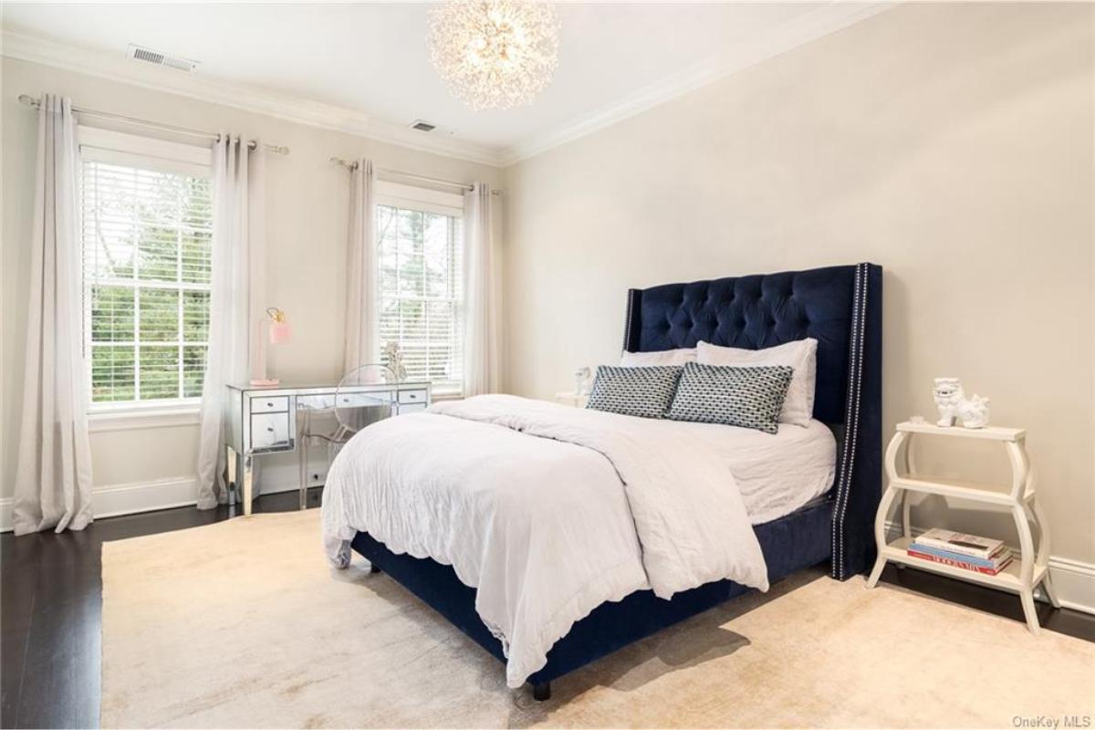 Stylish Bedroom with Plush Velvet Bed and Mirrored Desk