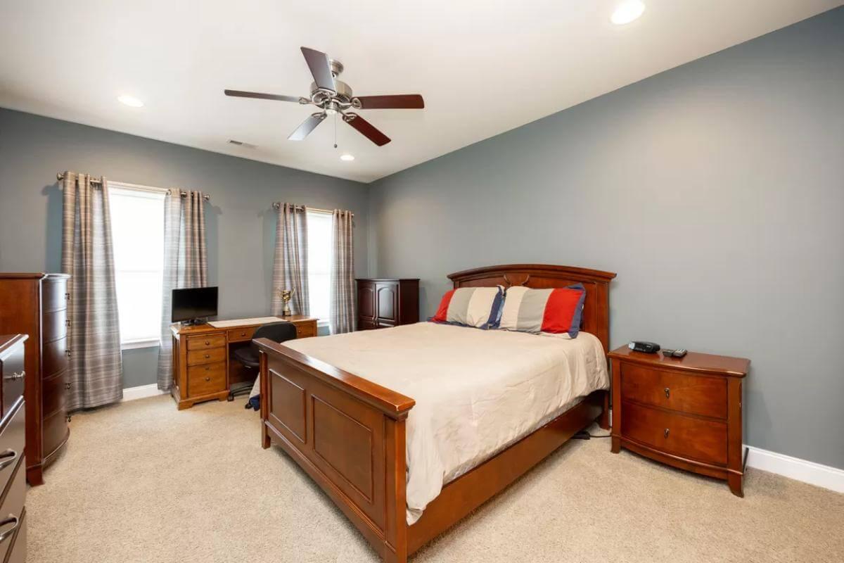 Simple Guest Bedroom with Sleigh Bed and Wood Desk
