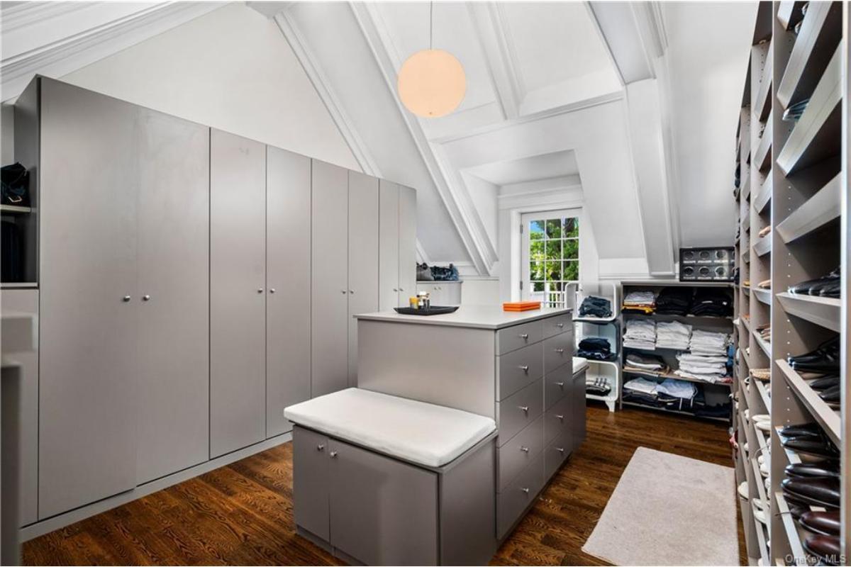 Explore This Impeccably Organized Walk-In Closet with Vaulted Ceilings