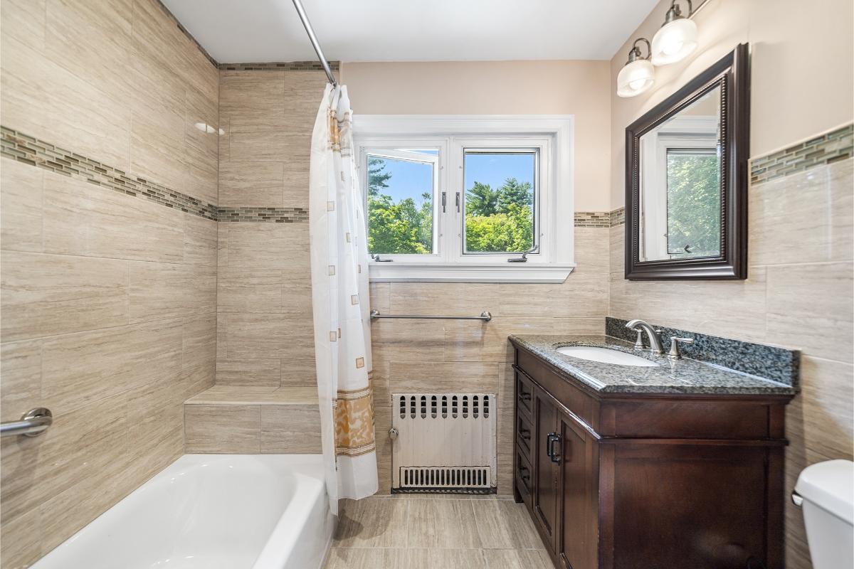 Serene Bathroom with Dark Wood Vanity and Subtle Tile Accents